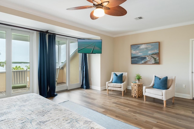 81250 Overseas Hwy Unit 1, Islamorada, FL 33036 - bedroom with access to exterior, crown molding, wood finished floors, and ceiling fan