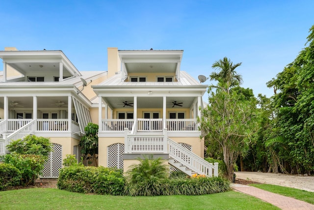 81250 Overseas Hwy Unit 1, Islamorada, FL 33036 - view of front of home with stairs, ceiling fan, and a front lawn