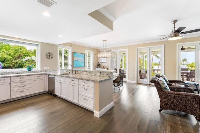 81250 Overseas Hwy Unit 1, Islamorada, FL 33036 - kitchen featuring crown molding, stainless steel dishwasher, dark wood finished floors, plenty of natural light, and light stone counters