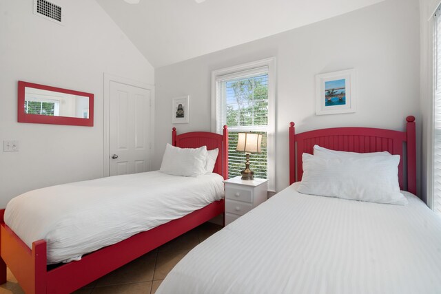 2600 Overseas Hwy Unit 87, Marathon, FL 33050 - tiled bedroom featuring vaulted ceiling
