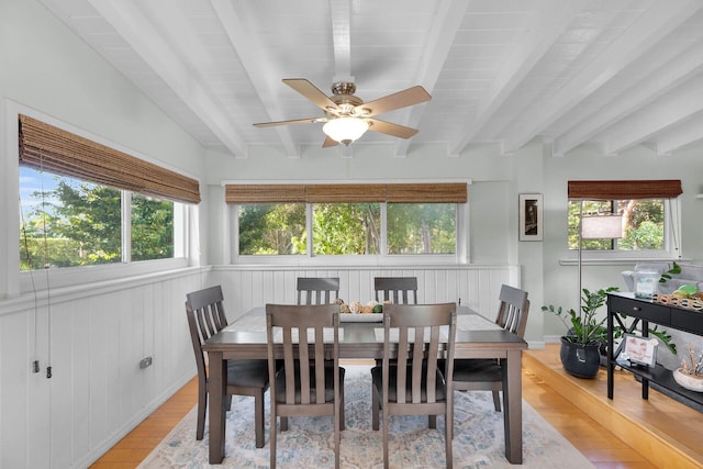 sunroom / solarium featuring beamed ceiling