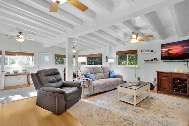 living area featuring wood finished floors, lofted ceiling with beams, and ceiling fan