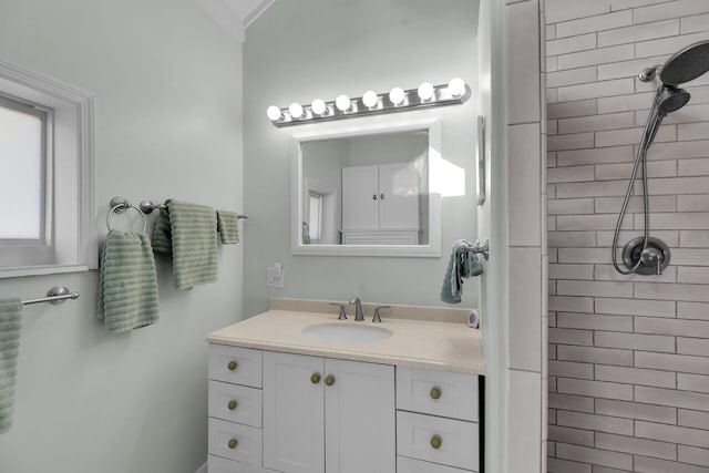 bathroom with vanity and tiled shower