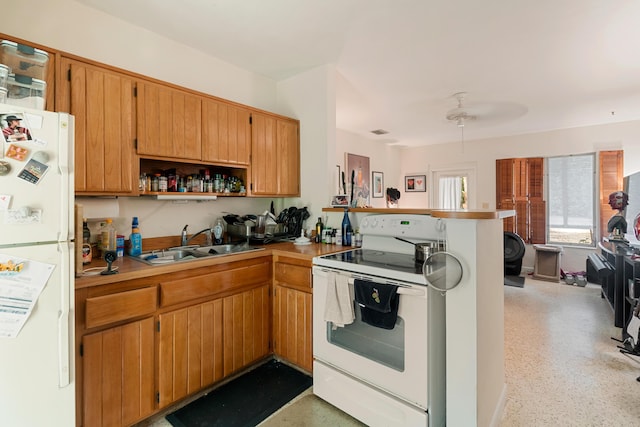 230 Apache St, Tavernier, FL 33070 - kitchen with white appliances, a peninsula, open shelves, dark speckled floor, and light countertops