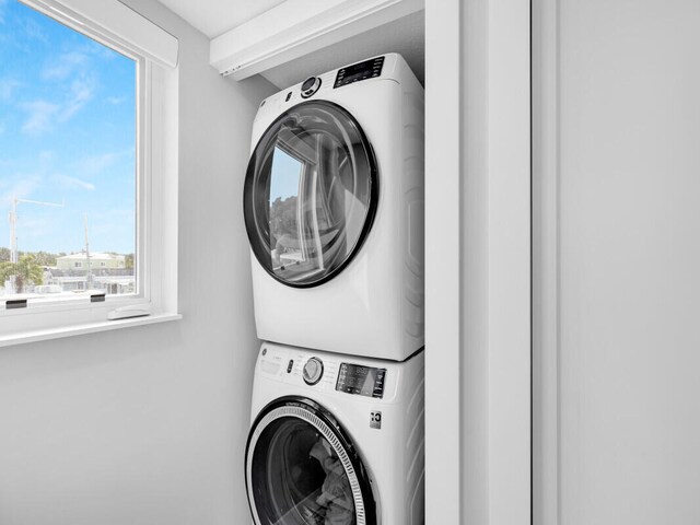 washroom with stacked washer and dryer