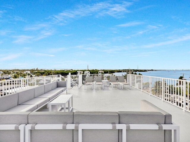 view of patio / terrace with an outdoor living space and a water view