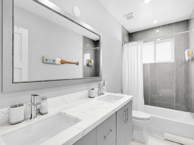 full bathroom featuring vanity, shower / bath combo, and toilet