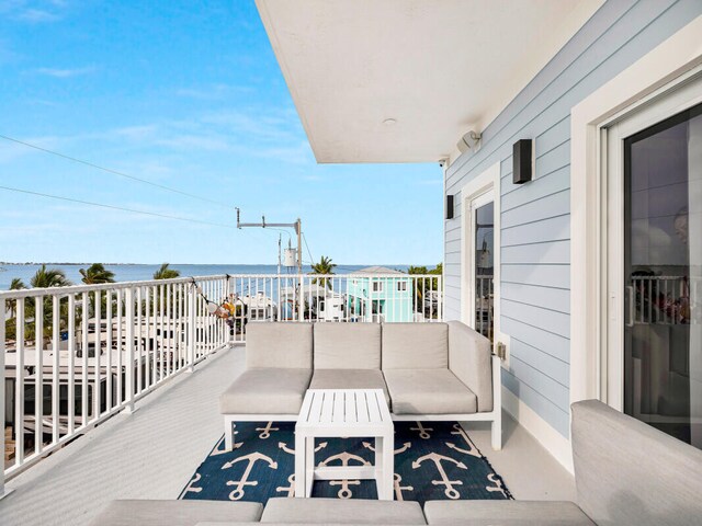 wooden deck with outdoor lounge area and a water view