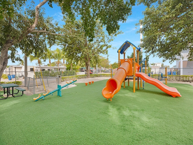 view of jungle gym featuring a lawn