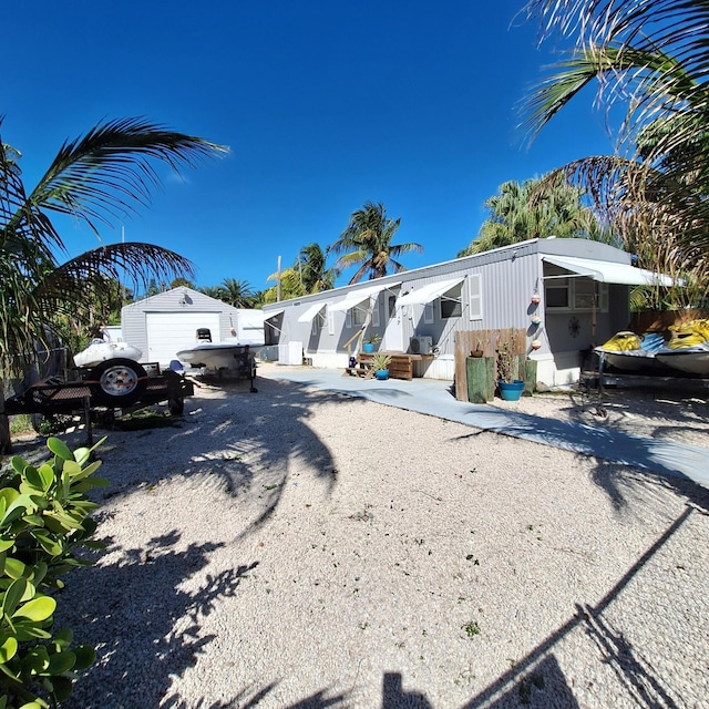 view of front of house featuring a garage and an outdoor structure