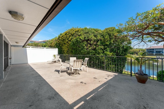 view of patio with outdoor dining space and a water view