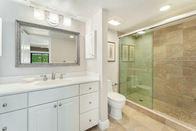 full bath with vanity, toilet, a stall shower, and tile patterned flooring