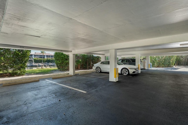 view of vehicle parking featuring a parking garage