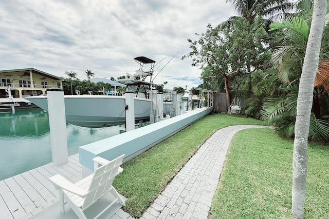 dock area with a water view and a yard