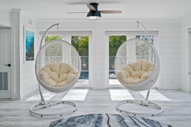 sunroom featuring plenty of natural light and ceiling fan