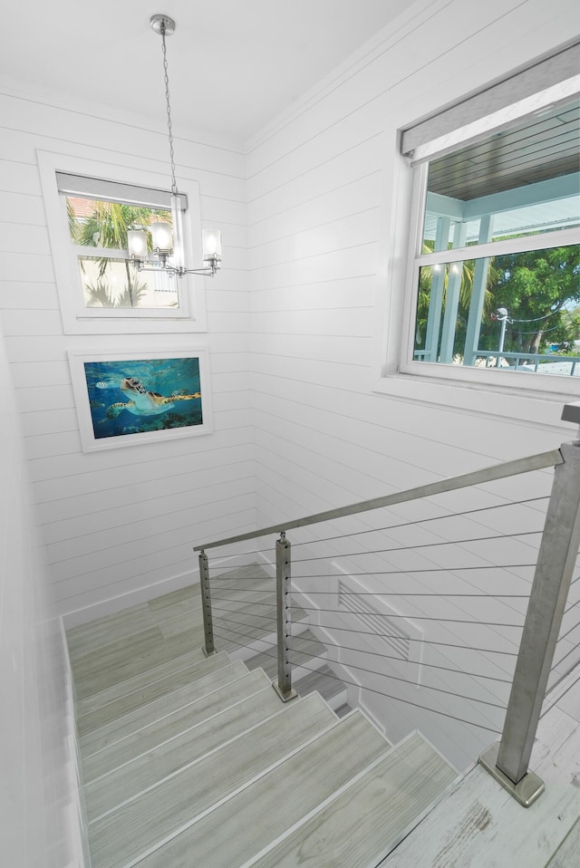 stairway featuring an inviting chandelier