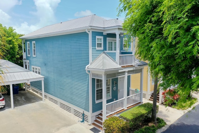 view of home's exterior with a carport, a balcony, and a porch