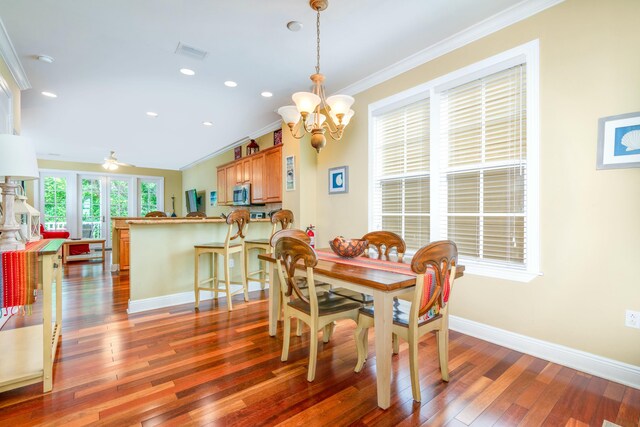 dining area featuring ornamental molding, dark hardwood / wood-style flooring, and ceiling fan with notable chandelier