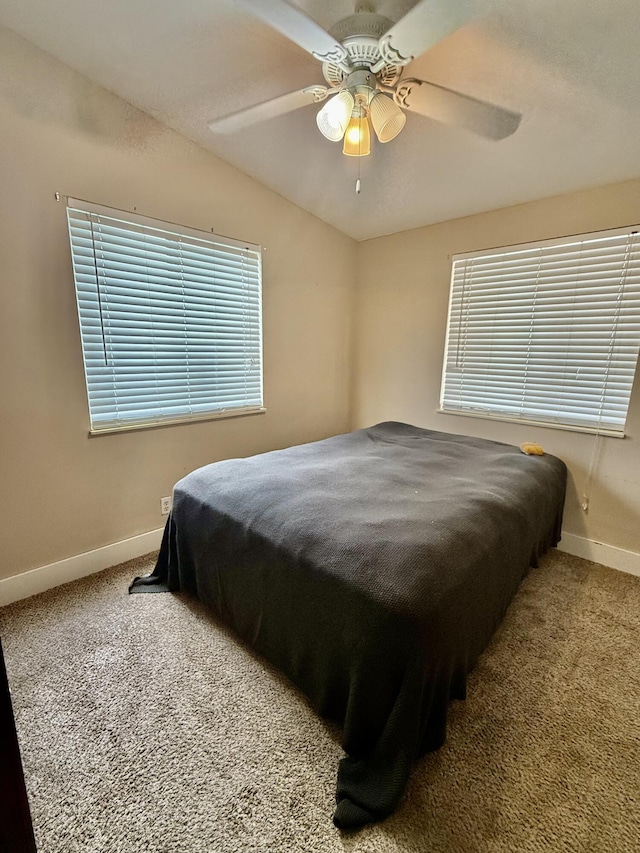 carpeted bedroom with ceiling fan and lofted ceiling