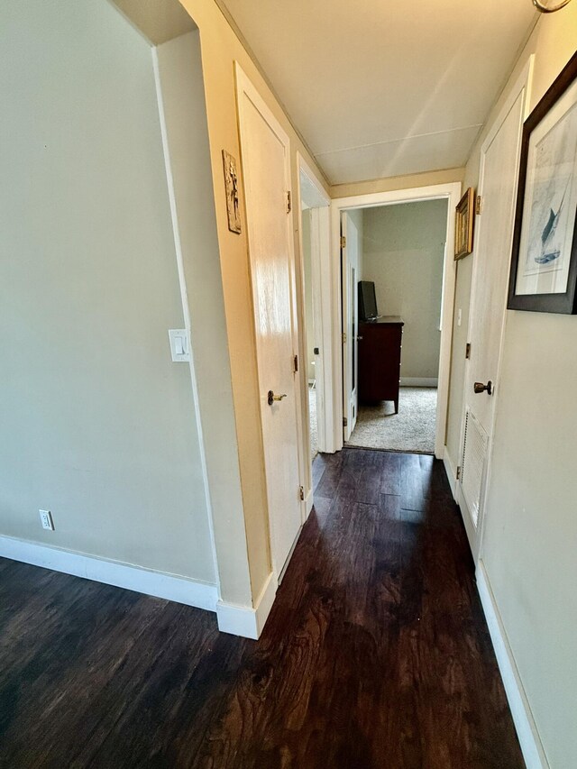 corridor with dark wood-type flooring