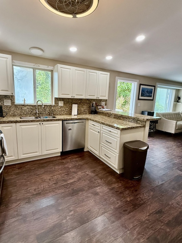 kitchen featuring light stone counters, stainless steel dishwasher, dark hardwood / wood-style flooring, and white cabinets