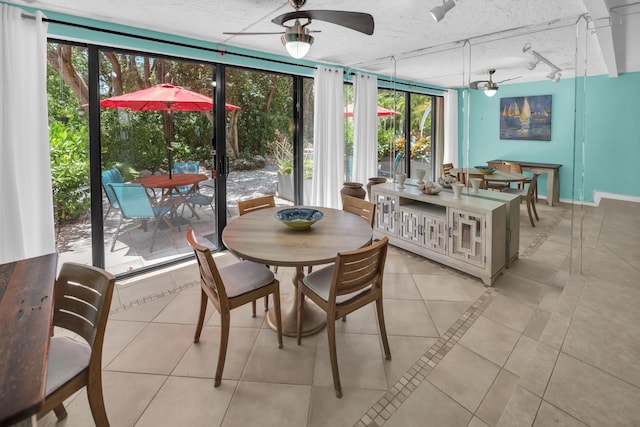 sunroom / solarium featuring track lighting