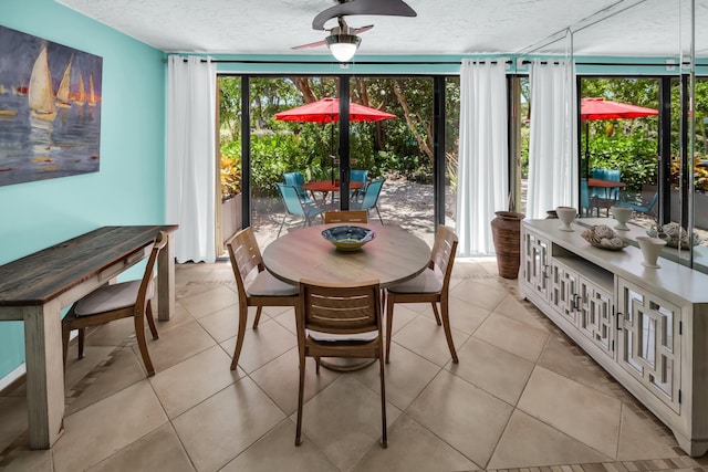 dining room featuring a textured ceiling, plenty of natural light, ceiling fan, and light tile patterned floors