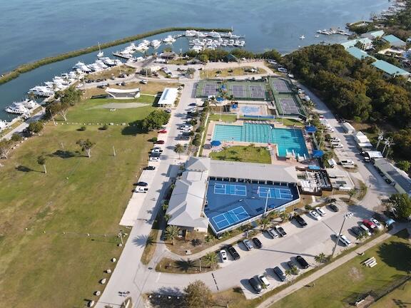 view of property location featuring a large body of water and a marina