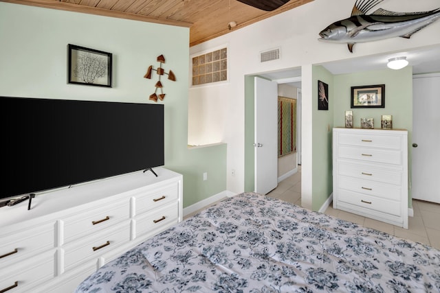 bedroom with wooden ceiling, light tile patterned floors, and baseboards