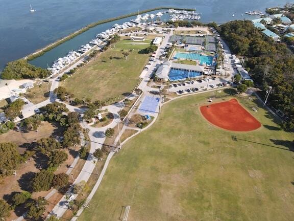 aerial overview of property's location with a nearby body of water and a pool area