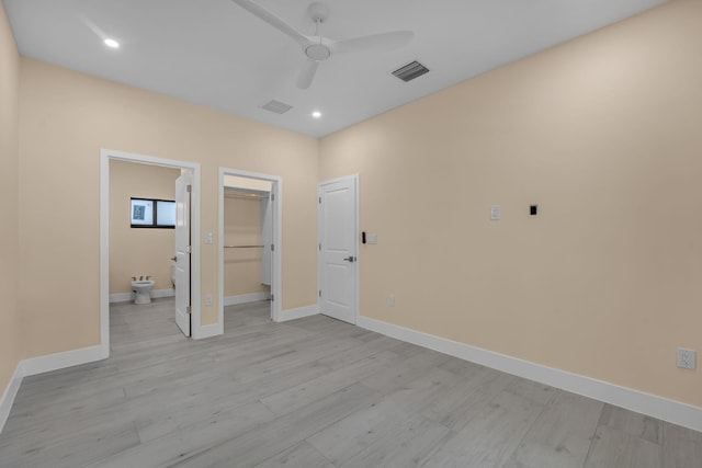 793 Oceana Ave, Key Largo, FL 33037 - unfurnished bedroom featuring light wood finished floors, recessed lighting, a spacious closet, connected bathroom, and a ceiling fan