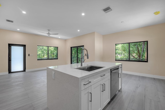 793 Oceana Ave, Key Largo, FL 33037 - kitchen with stainless steel dishwasher, ceiling fan, an island with sink, open floor plan, and light countertops