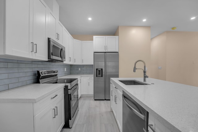793 Oceana Ave, Key Largo, FL 33037 - kitchen featuring stainless steel appliances, white cabinetry, backsplash, and recessed lighting