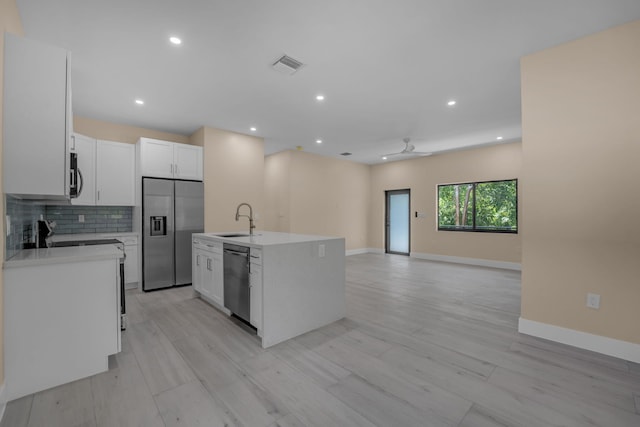 793 Oceana Ave, Key Largo, FL 33037 - kitchen with stainless steel appliances, ceiling fan, open floor plan, light countertops, and white cabinets