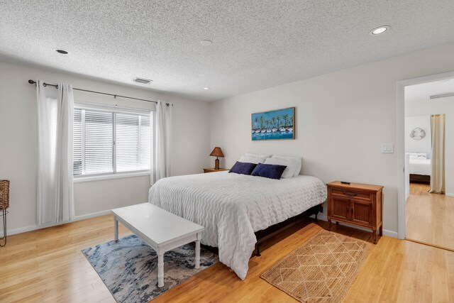 1519 Johnson St, Key West, FL 33040 - bedroom with hardwood / wood-style floors and a textured ceiling