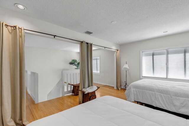 1519 Johnson St, Key West, FL 33040 - bedroom featuring hardwood / wood-style floors and a textured ceiling