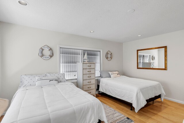 1519 Johnson St, Key West, FL 33040 - bedroom with hardwood / wood-style flooring and a textured ceiling