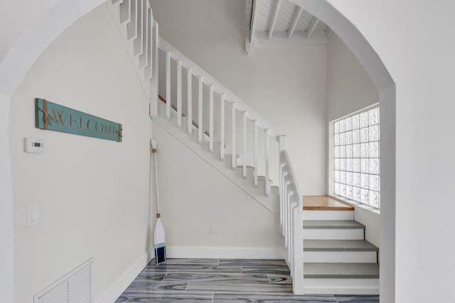 1519 Johnson St, Key West, FL 33040 - staircase featuring beamed ceiling and hardwood / wood-style floors