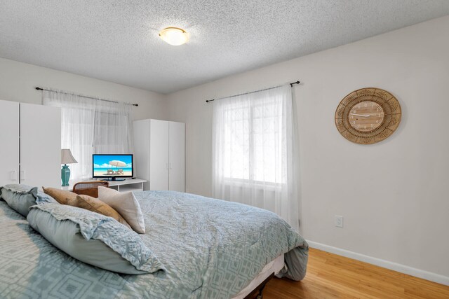 1519 Johnson St, Key West, FL 33040 - bedroom with wood-type flooring and a textured ceiling