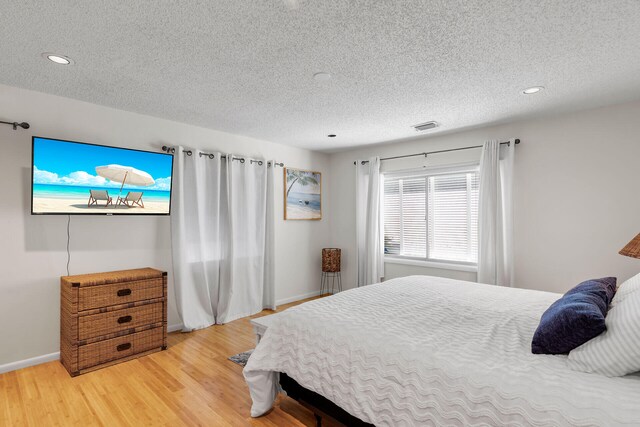 1519 Johnson St, Key West, FL 33040 - bedroom with wood-type flooring and a textured ceiling
