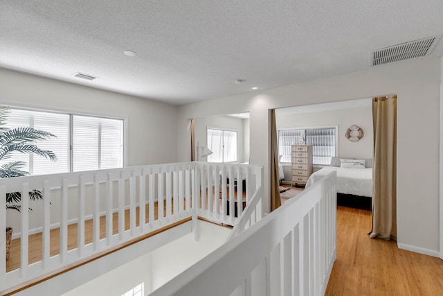 1519 Johnson St, Key West, FL 33040 - corridor featuring a textured ceiling and light hardwood / wood-style floors