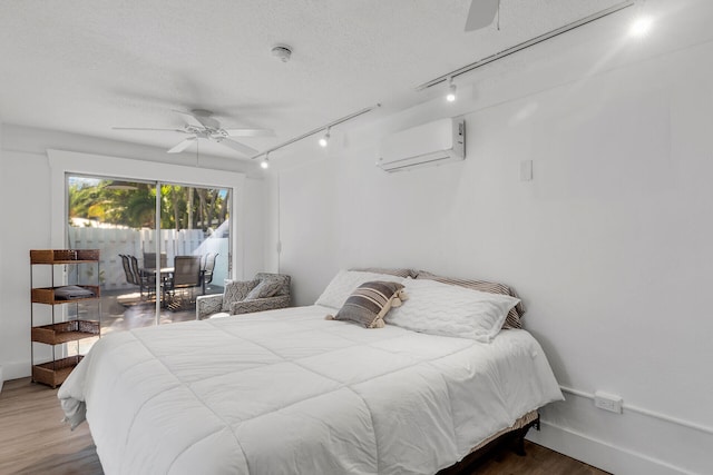 1519 Johnson St, Key West, FL 33040 - bedroom with ceiling fan, hardwood / wood-style floors, a textured ceiling, access to outside, and an AC wall unit