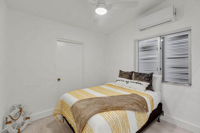 1519 Johnson St, Key West, FL 33040 - bedroom featuring a wall mounted air conditioner, ceiling fan, and light hardwood / wood-style flooring