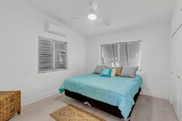1519 Johnson St, Key West, FL 33040 - bedroom featuring ceiling fan, light wood-type flooring, a closet, and an AC wall unit