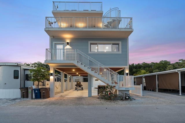 coastal inspired home with stairway and a balcony