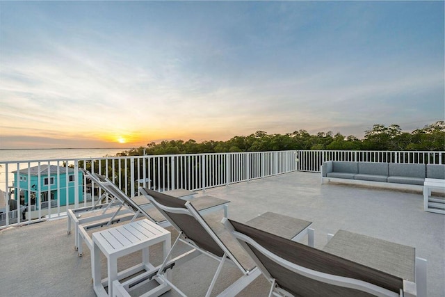 view of patio featuring an outdoor living space and a water view