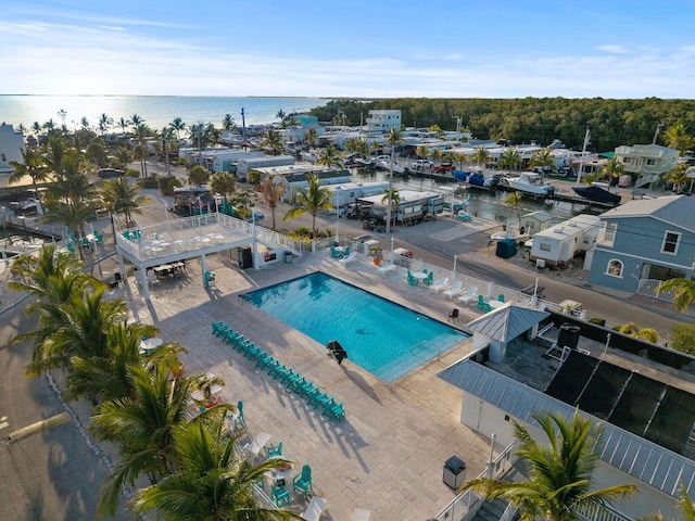 bird's eye view of a pool area and a nearby body of water