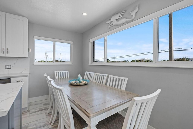 dining area with light marble finish floors, recessed lighting, and baseboards