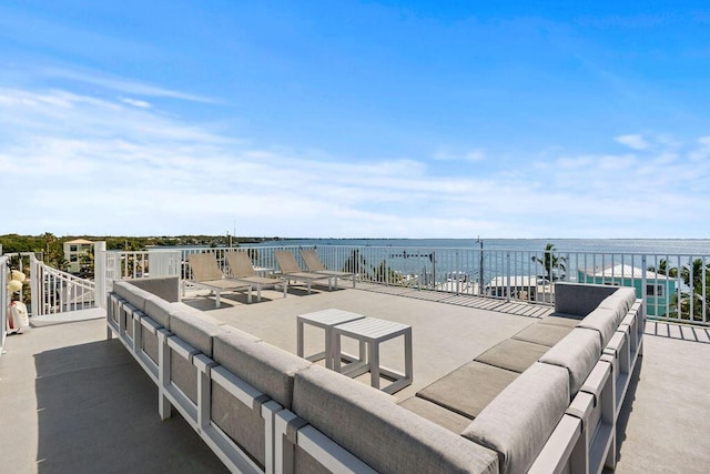 view of patio with a water view and an outdoor hangout area