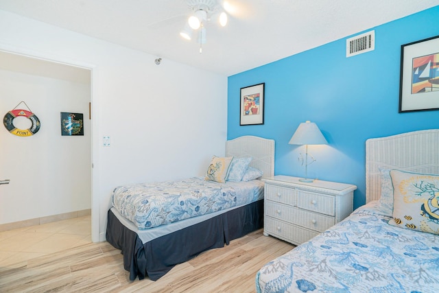 bedroom featuring ceiling fan and light hardwood / wood-style flooring